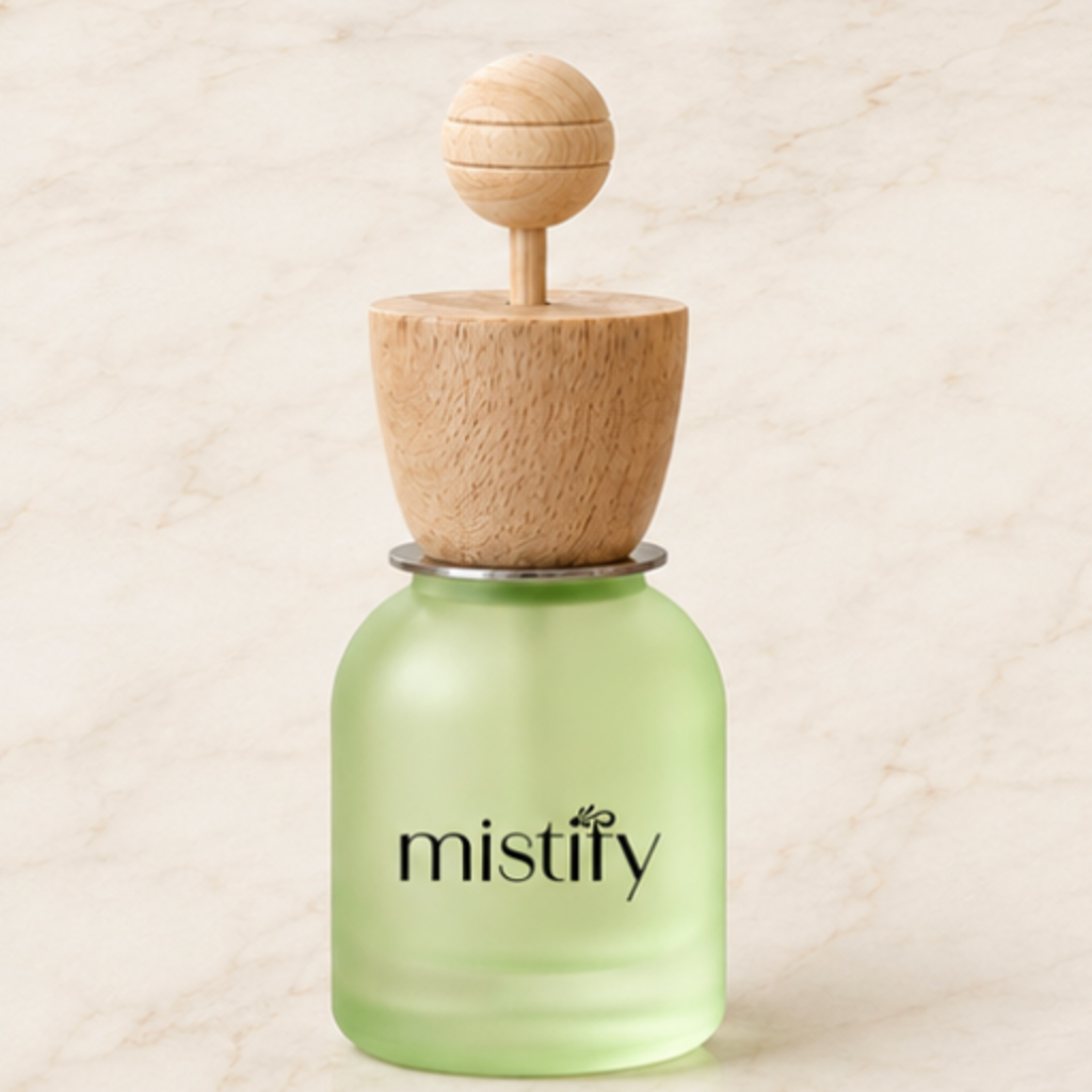 Light green Mistify Parfums car diffuser with adjustable scent vent, designed to add fragrance to your vehicle interior.